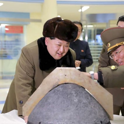 North Korean leader Kim Jong-un looks at a rocket warhead tip. Photo: Reuters