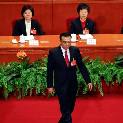 Premier Li Keqiang walks onstage to deliver a government work report during the opening session of the National People's Congress. Photo: Reuters