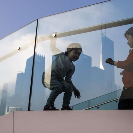 Children play on a viewing platform in Hong Kong. The debate over declining foreign language standards in Hong Kong is a tired one, but its verdict should be clear: if the city is to live up to its self-styled reputation as “Asia’s World City”, our students need to learn world languages. Photo: AFP
