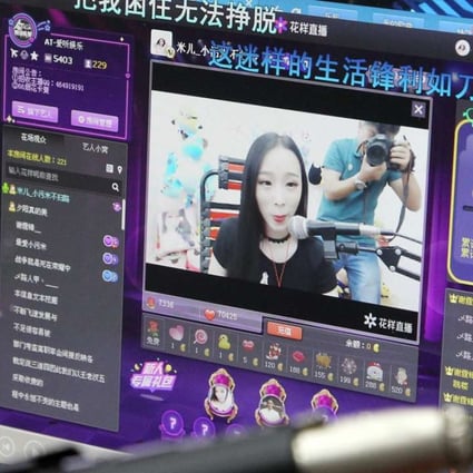 Xiao Mi (web name), an internet broadcast host, performing in her studio during a live web streaming in Zhengzhou, Henan province. Xiao Mi generally makes six hours of live streaming daily for her fans on the internet, and claims her monthly income can be upwards of 20,000 yuan (US$2,900). (Imaginechina)
