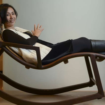 Chinese designer Jiang Qionger of brand Shang Xia poses with her Da Tian Di rocking chair at Lane Crawford Home Store in Pacific Place, Admiralty, Hong Kong. Photo: Antony Dickson