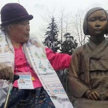 Ahn Jeom-soon, a 90-year old former South Korean comfort women, sits next to a statue in memory of the comfort women in Wiesent, Germany, on Wednesday. Photo: Yonhap News