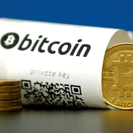 A Bitcoin paper wallet with QR codes and a coin are seen in an illustration picture taken at La Maison du Bitcoin in Paris, France. Photo: Reuters