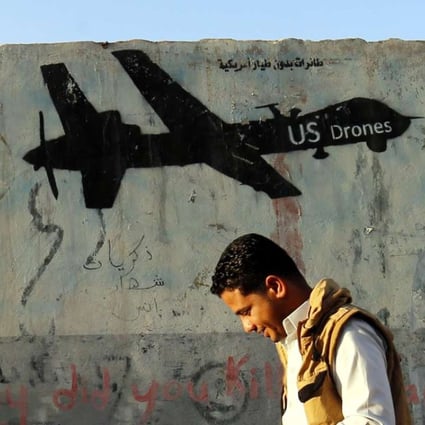 A Yemeni walks past graffiti protesting US drone operations a day after US airstrikes bombarded al-Qaeda positions in war-affected Yemen, where another air strike on a market killed 26 on Friday, March 10, 2017. Photo: EPA