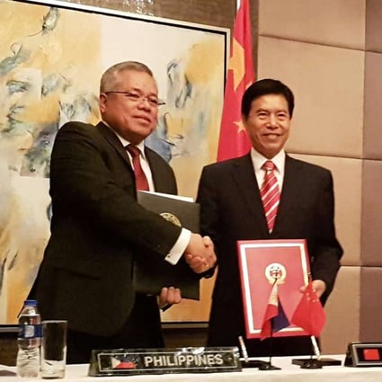 Philippine Trade Secretary Ramon Lopez shakes hands with China's Commerce Minister Zhong Shan in Manila last week. Photo: Reuters