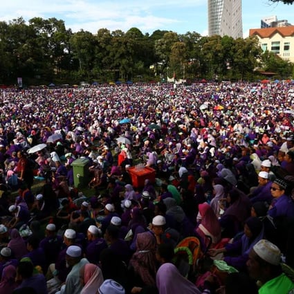 A rally in Kuala Lumpur calls for elements of a strict Islamic penal code to be adopted. Photo: Reuters
