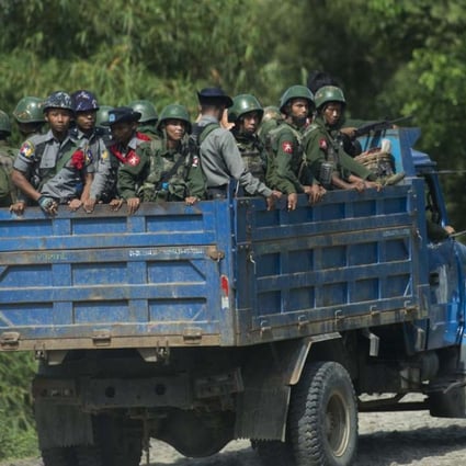 Armed military troops and police force travelling in trucks through Maungdaw, located in Rakhine State. File photo: AFP