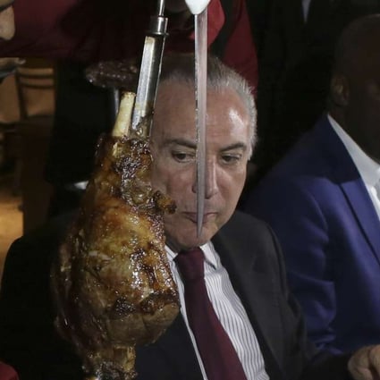 Brazilian President Michel Temer attends a steak dinner at a traditional Brazilian barbecue restaurant after a meeting on the rotten meat scandal. Photo: AP