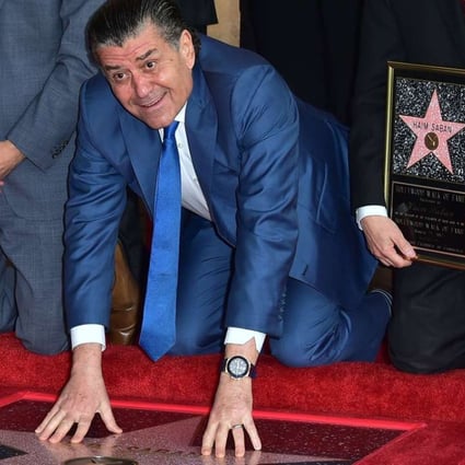 Producer and Power Rangers creator Haim Saban touches his Hollywood Walk of Fame star on Wednesday. Photo: AFP