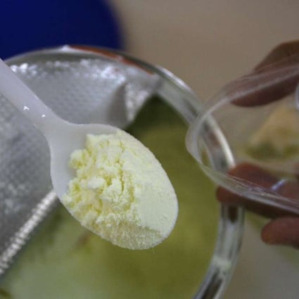 A file picture of a health official checking baby milk powder. Photo: Reuters