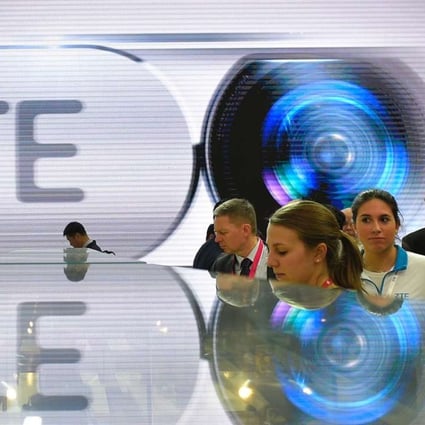 ZTE says it has been removed from the Entity List upon recommendation of the Bureau of Industry and Security. Visitors testing smart phones at ZTE's stand during the Mobile World Congress in Barcelona. Photo: AFP