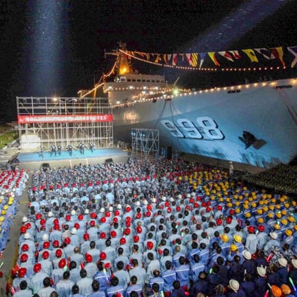 A file picture of one China’s previous-generation amphibious vessels, the Kunlun Shan, after it docked in Fiery Cross Reef in the disputed Spratly Islands in the South China Sea last year for a concert given to military personnel and workers. Photo: China News Service