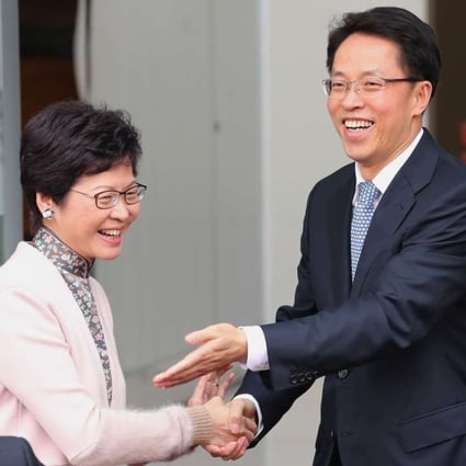 Carrie Lam is greeted by liaison office director Zhang Xiaoming. Photo: Edward Wong