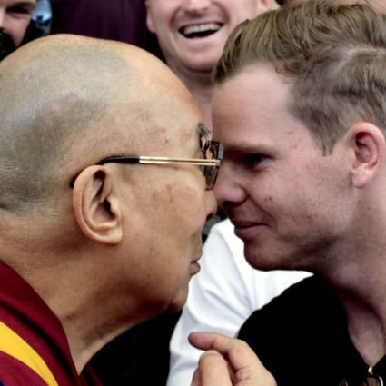 Tibetan spiritual leader the Dalai Lama and Australian cricket team captain Steven Smith rub their noses during an interaction with the team at the Tsuglakhang temple in Dharamsala, India. Photo: Getty