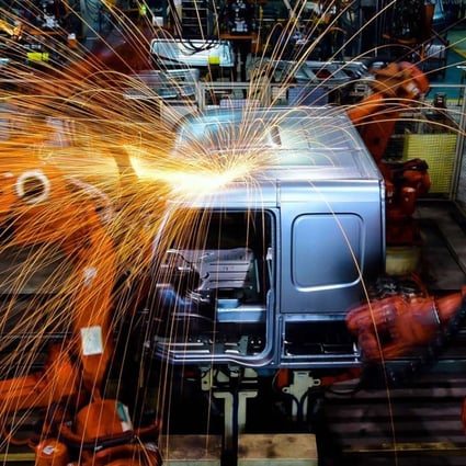 A robot welds parts at Jinan Truck Company in China's Shandong province. More than 50 per cent of annual robotics spending on the mainland is for so-called discrete manufacturing, which is the assembly-line production of distinct products like cars and smartphones. Photo: Xinhua