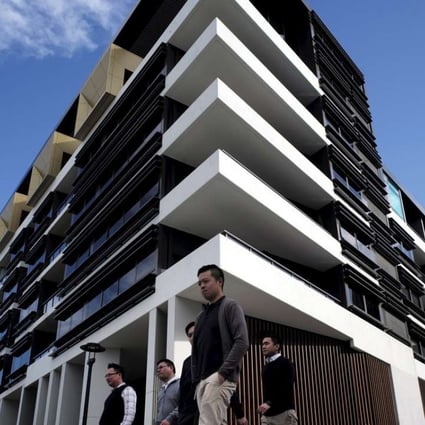 Sydney residents walk past a newly-completed apartment development in Sydney's inner-city suburb of Zetland. The country’s banking watchdog is keeping a close eye on the country’s red-hot housing market. Photo: Reuters