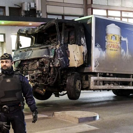 Tow trucks move the beer truck that crashed into the Ahlens department store after ploughing down Drottninggatan Street in central Stockholm, Sweden. Photo: EPA