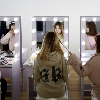 Girls attend a make-up training session at live-streaming talent agency Three Minute TV in Beijing in February. The company also arranges for employees to have cosmetic surgery at partner hospitals and small bank loans for the procedure. Photo: Reuters