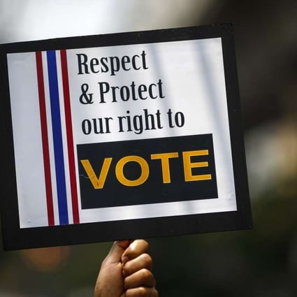 A man holds a placard during a rally demanding the right to vote be respected. File photo: Reuters