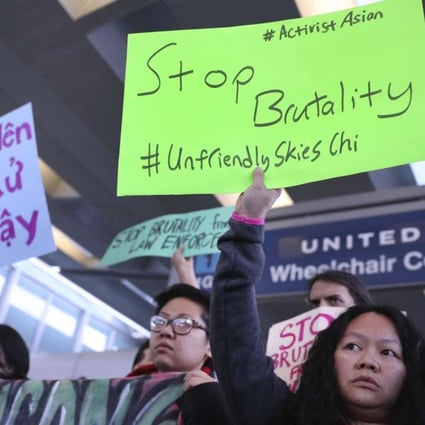 People from Asian community groups protest on Tuesday at Chicago’s O'Hare International Airport. Photo: AP