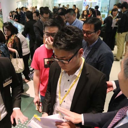 As many as 900 buyers registered to bid for 152 apartment units put on the market by Cheung Kong Property Holding. The developer sold 142 units of the Harbour Glory project within four hours. An estimated 30 per cent of the buyers showed up in groups, buying multiple units but under different names to work around a government stamp duty.Photo: Felix Wong