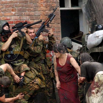 Russian special forces take cover during the rescue operation of Beslan's school. File photo: AFP