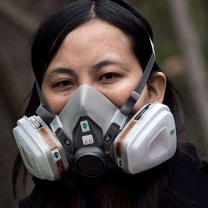 A woman wears a protective mask on a street in Beijing in March. Photo: AFP