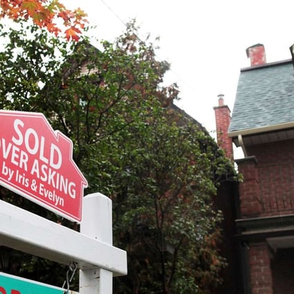 A sold sign is on display outside a house in Toronto, where the red-hot housing market rose more than 30 per cent last year. Photo: Reuters