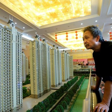 A visitor at a showroom of Evergrande Real Estate Group in Wuhan, Hubei province. The company bought back HK$3.22 billion worth of shares between April 13 and 20. Photo: Reuters