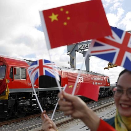 Chinese women wave flags at the official ceremony earlier this month to mark the departure of the first UK-to-China freight train, laden with containers of British goods, from the DP World London Gateway, in Stanford-le-Hope, east of central London. Photo: Reuters