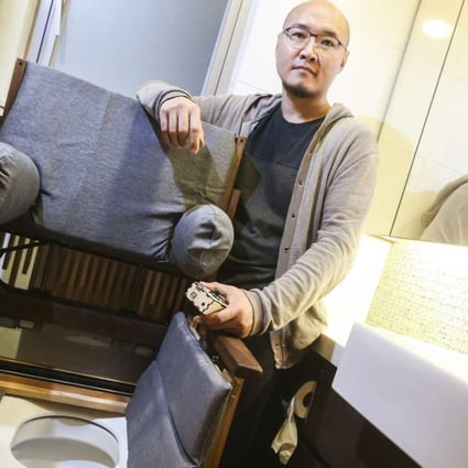 Chun Kwok-tung with the wheelchair he designed at his home in Tsing Yi.Photo: K.Y. Cheng