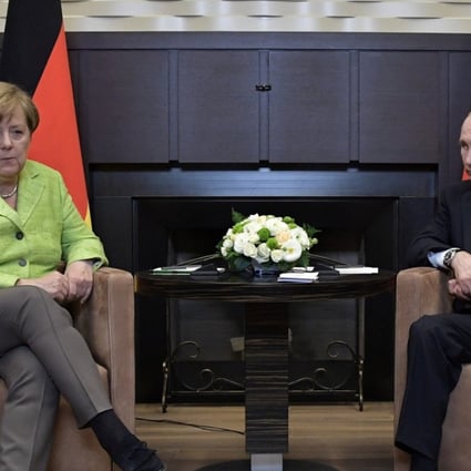 Russian President Vladimir Putin meets with German Chancellor Angela Merkel. Photo: Reuters