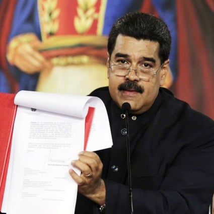 Venezuelan President Nicolas Maduro showing a decree paving the way to a new constitution, in Caracas on MOnday. Photo: EPA