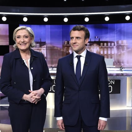 Marine Le Pen (L) and Emmanuel Macron (R) pose prior to the start of the final debate in the French presidential elections where they traded insults. Photo: EPA
