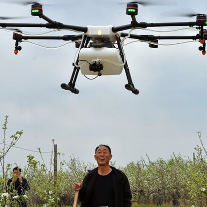 A farmer watches as a drone sprays pesticide in his field in Shanxi province. By 2025 agricultural and forestry drones are expected to be a 20 billion yuan market in China. Photo: Xinhua