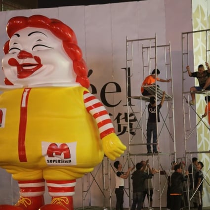Ron English’s giant MC Supersized figure being removed from outside the Reel Department Store in Shanghai.