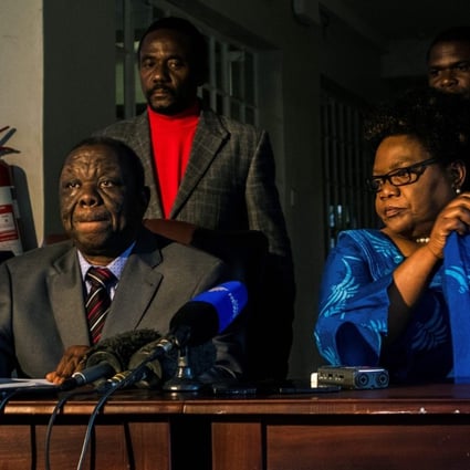 A file photo taken on April 19 shows Zimbabwe main opposition leader Morgan Tsvangirai (left) and former vice president Joice Mujuru in Harare signing a Memorandum of Understanding to negotiate a coalition ahead of the 2018 general election. Photo: AFP