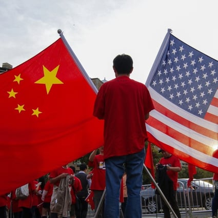 Demonstrators with Chinese and United States national flags gather at sunset in Washington in 2015. Photo: EPA
