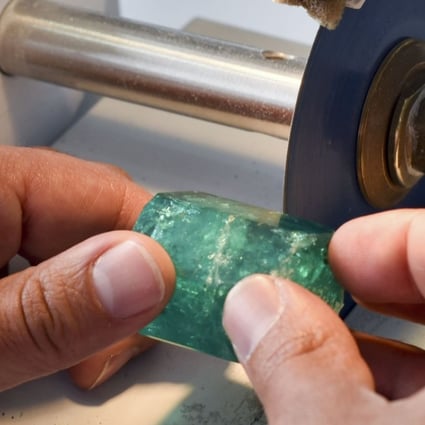 A worker cuts an emerald at the workshop of Muzo Emerald Company in Bogota. Colombian emeralds are considered to be the most beautiful in the world. Photo: AFP