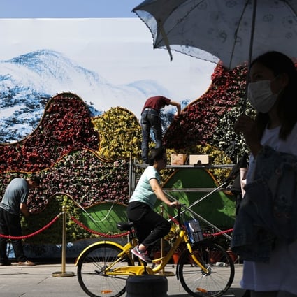 Workers plant flowers near the Xidan Cultural Square ahead of the Belt and Road Forum in Beijing. Photo: AP