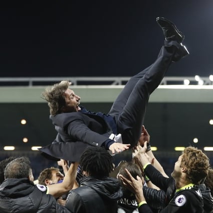 Chelsea manager Antonio Conte is thrown in the air by his players as they celebrate winning the Premier League title. Photo: Reuters
