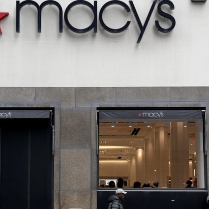 People walk in front of a Macy's Store in Brooklyn, New York. May's stock dropped more than 17 per cent following a disappointing earnings report and other stores suffered from the weakening performance of the sector. Photo: EPA