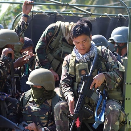 Philippine soldiers head to an area of unrest on Boho Island. Photo: EPA