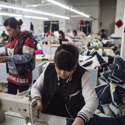 People work at a textile factory that will be relocated in Anxin, in China's Hebei province, on April 5, 2017. China will create a new special economic zone outside Beijing similar to those established in Shenzhen and Shanghai, the government said, in a bid to boost flagging growth and reduce the strain on the capital. Photo: AFP