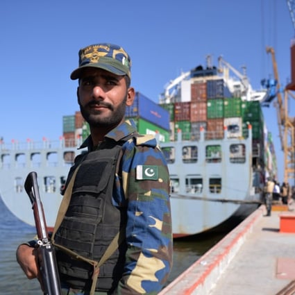 A Pakistani guard beside a ship docked at Gwadar port. Photo: AFP