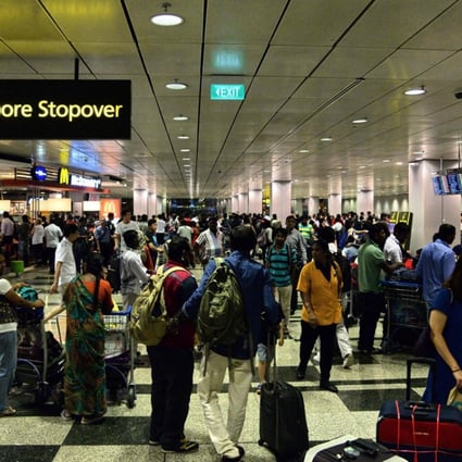 Passengers gather at Changi International Airport terminal 3 after being evacuated from terminal 2 due to a fire. Photo: AFP