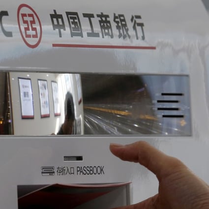 A customer takes her bankbook from a smart banking machine at a branch of ICBC bank in Beijing, China. Net foreign exchange sales by Chinese bank touch a three-month high in April. Photo: Reuters