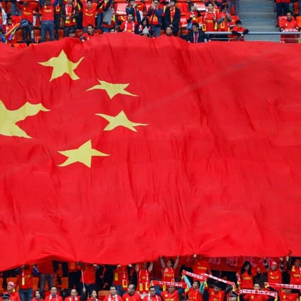 Fans hold a Chinese national flag at the China Cup mini-tournament in January this year. Photo: REUTERS