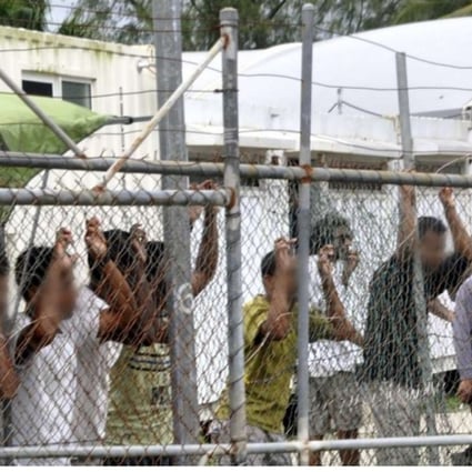 Asylum seekers behind a fence at the Manus Island detention centre, in Papua New Guinea. File photo: EPA
