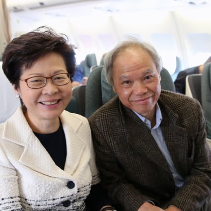 Carrie Lam with husband Lam Siu-por on a flight to Beijing. Photo: Sam Tsang
